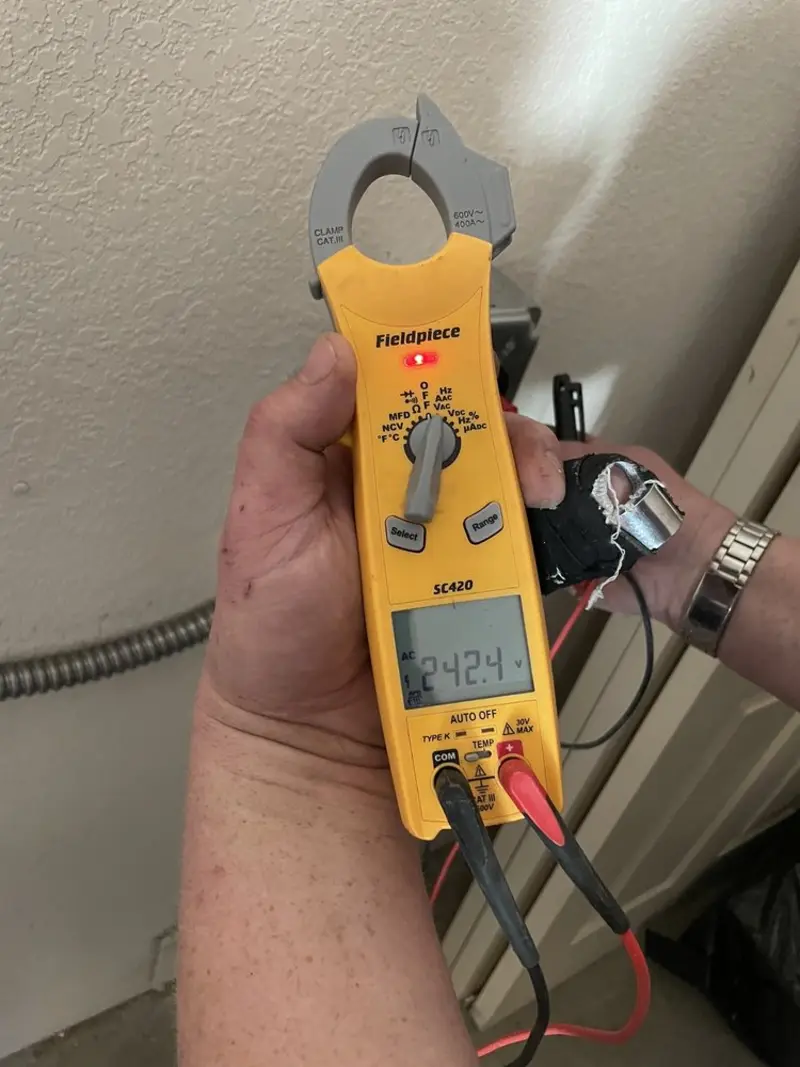 Voltage testing with clamp meter during Outlet Installation in Oak View